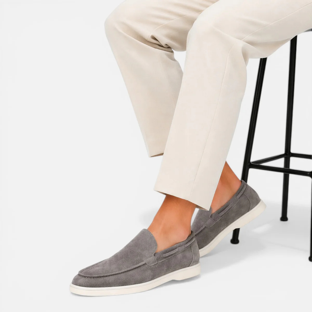 Men's gray suede casual loafers on model with moc toe and cushioned sole