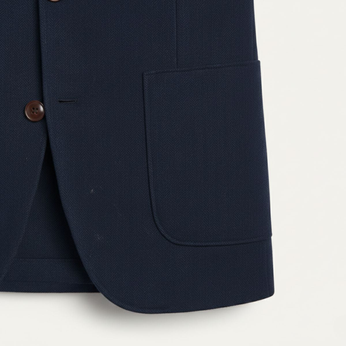 Navy blue wool blazer with brown button, side pocket, and clean hem cuff