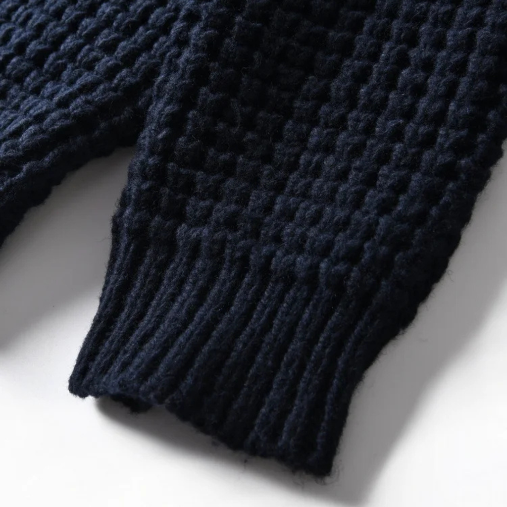 Navy chunky knit cardigan sleeve and hem detail with textured stitch pattern