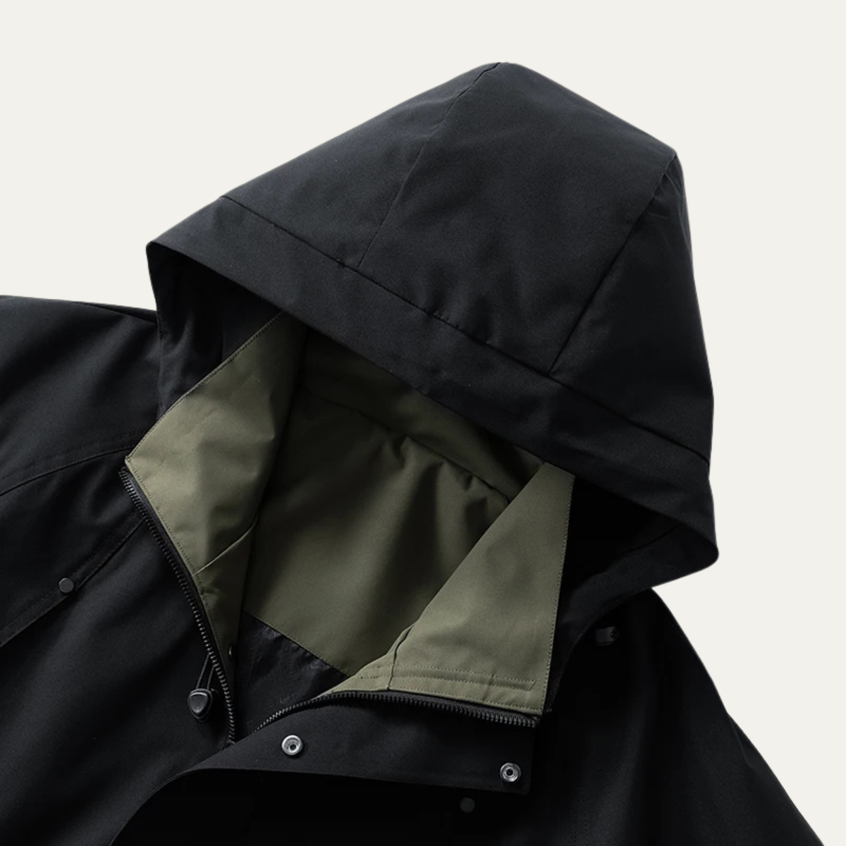 Black hooded waterproof rain jacket with adjustable zipper and snap cuffs, interior lining visible