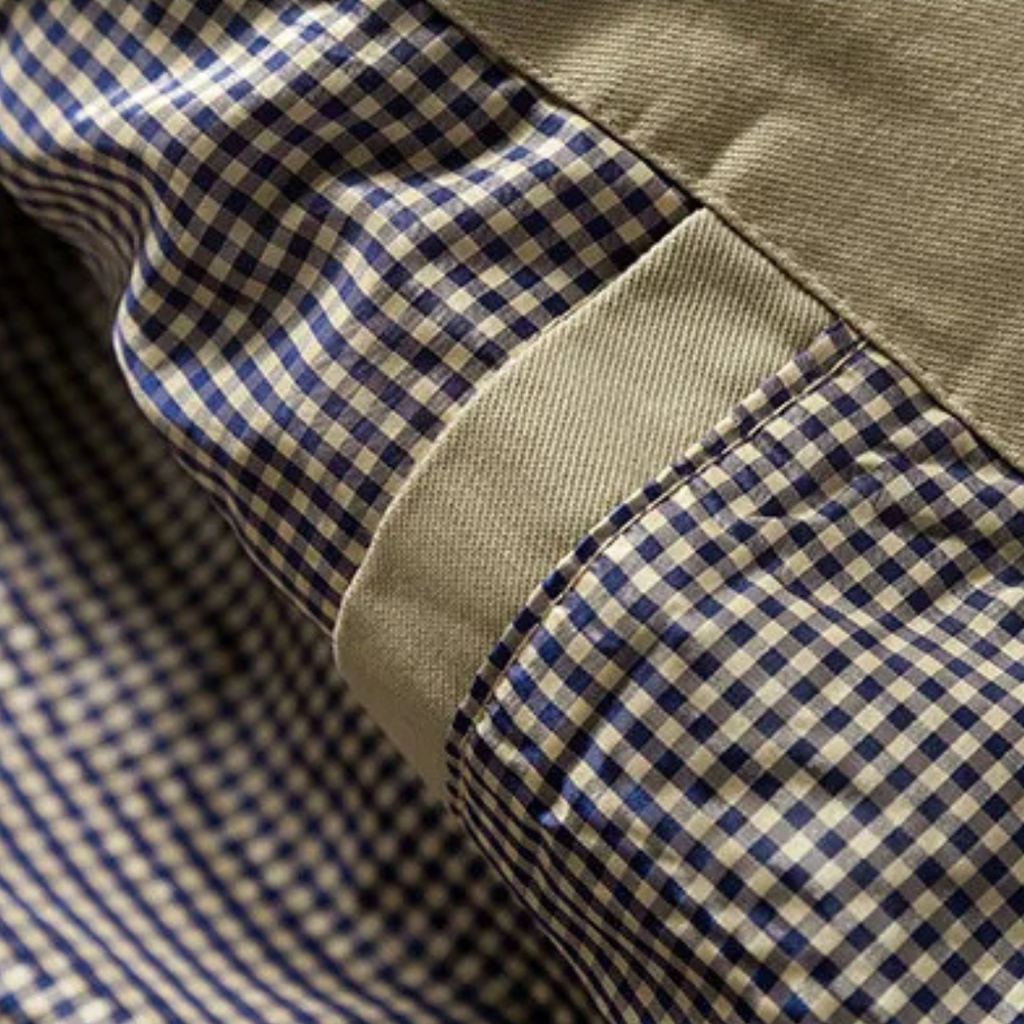 Men's tan trench coat lining close-up with blue-and-white check pattern