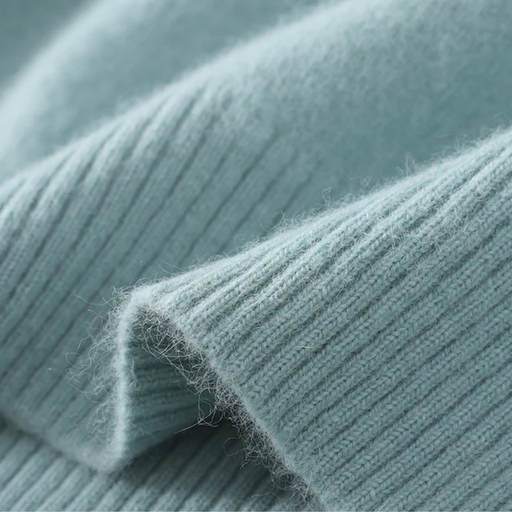 Light blue knit sweater fabric close-up, soft texture