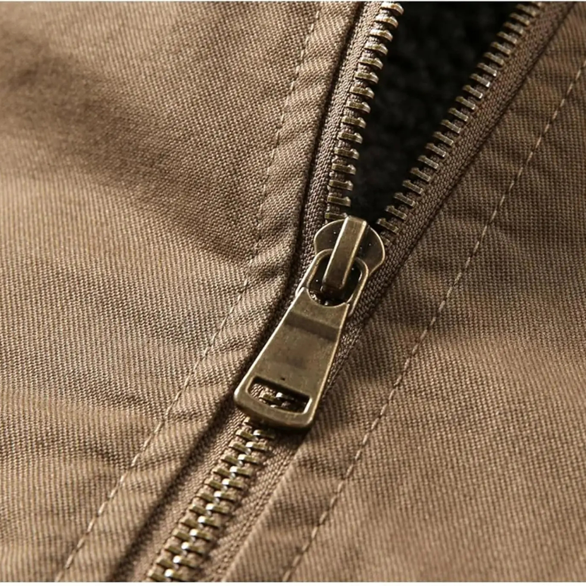 Brown quilted shearling bomber zipper with metal pull and stitched panel