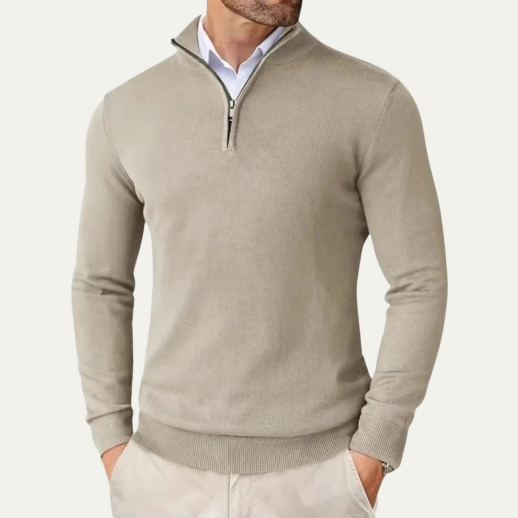 Men's beige half-zip knit sweater worn with collared shirt, ribbed hem