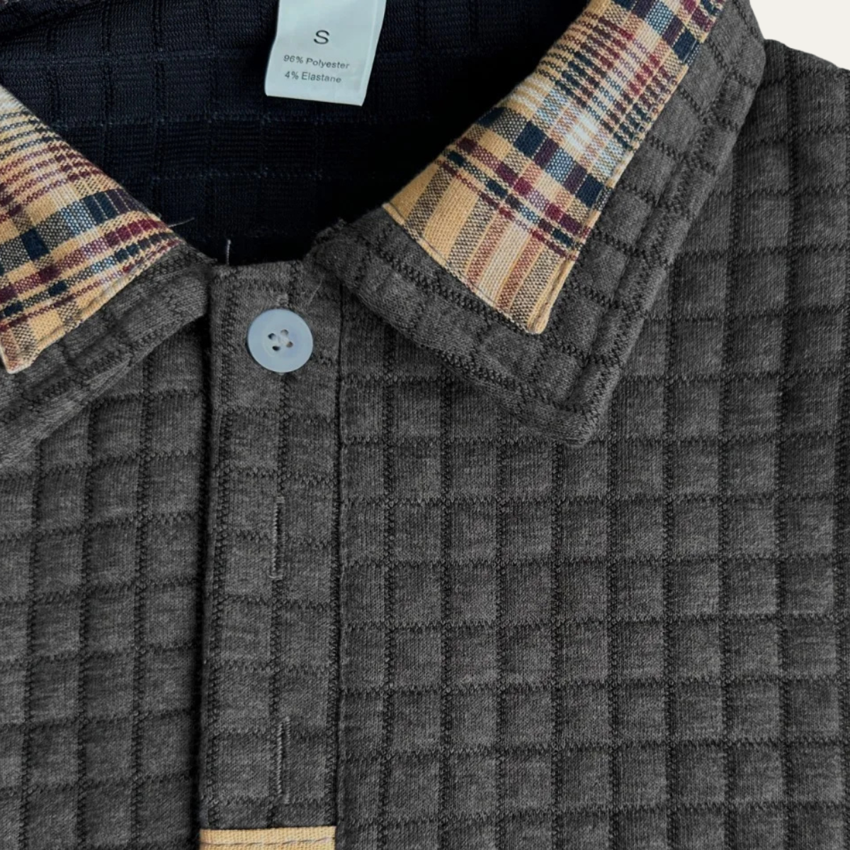 Dark waffle-knit polo collar with plaid inner placket and button closure