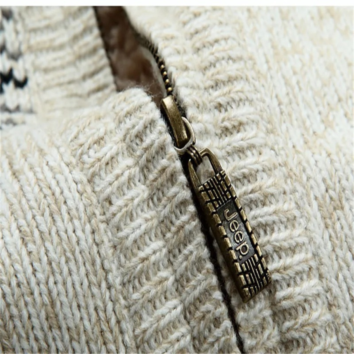 Cream knit zip-up cardigan close-up with metal zipper pull and sherpa lining