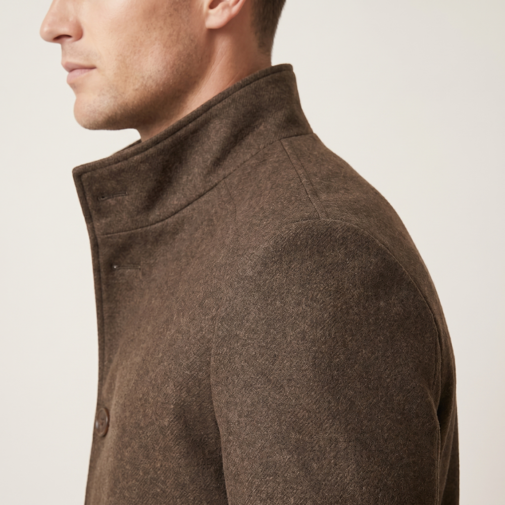 Brown wool overcoat shoulder and arm seam with stand collar detail