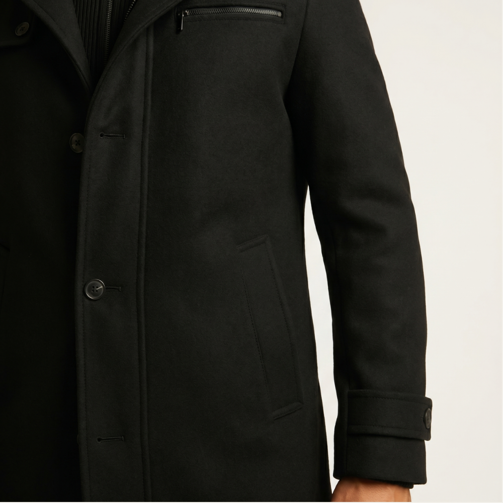 Black wool-blend overcoat sleeve and front panel, side pocket, buttoned cuff tab