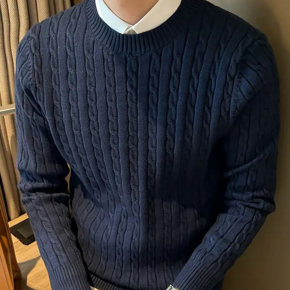 Navy cable-knit crewneck sweater with detailed cable texture and ribbing
