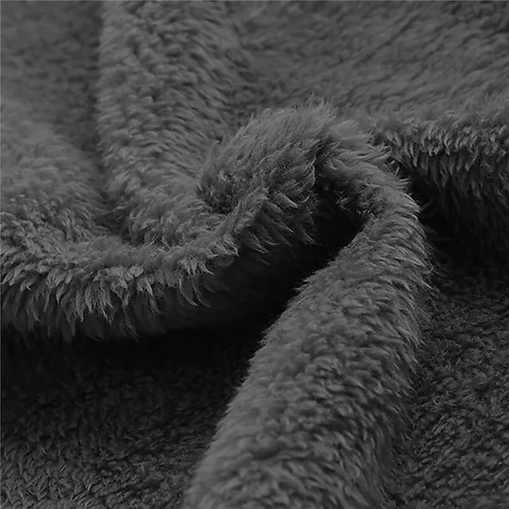 Close-up of dark gray fuzzy fleece lining for a hooded winter jacket.