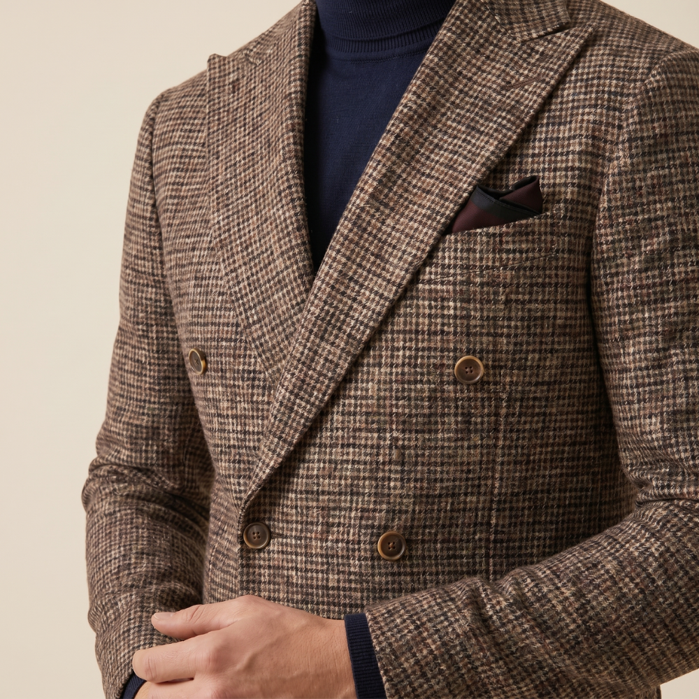Men's brown tweed double-breasted blazer close-up, flap pockets and dark buttons