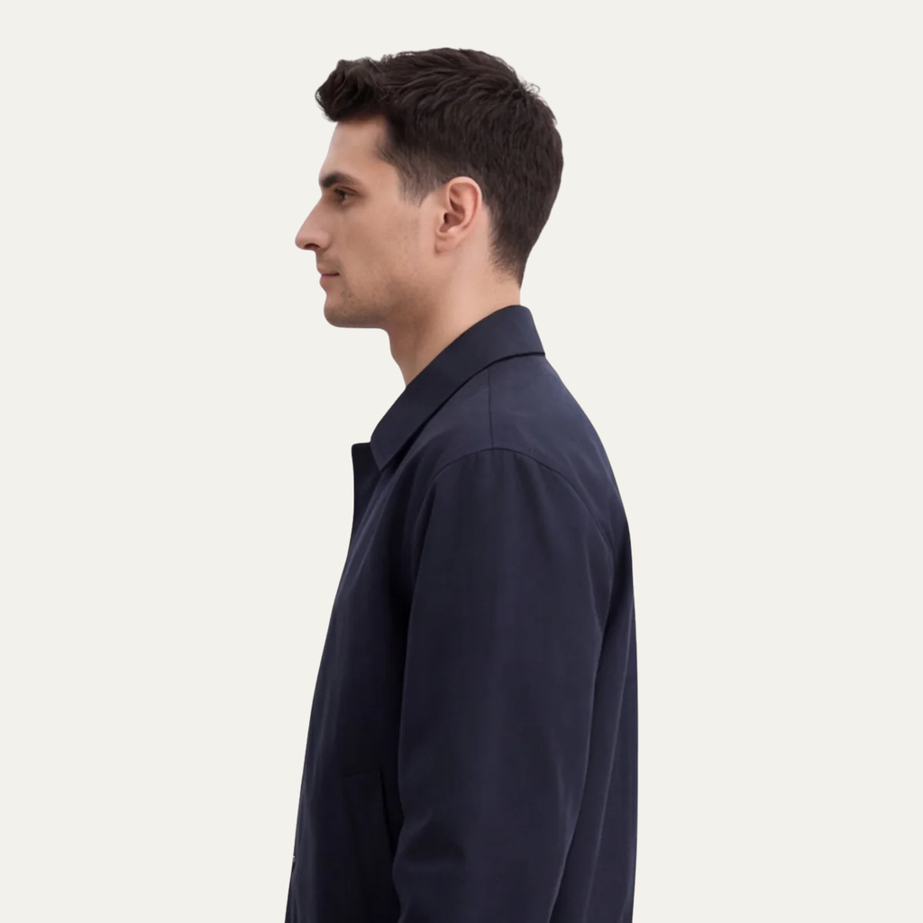 Men's navy lightweight button jacket shown in side profile with point collar