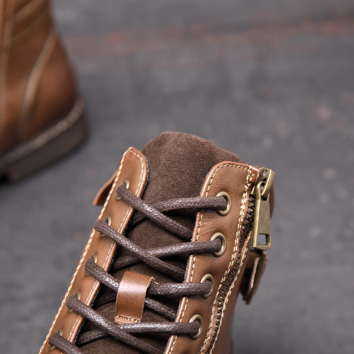Brown ankle boot with lace-up closure and side zipper detail
