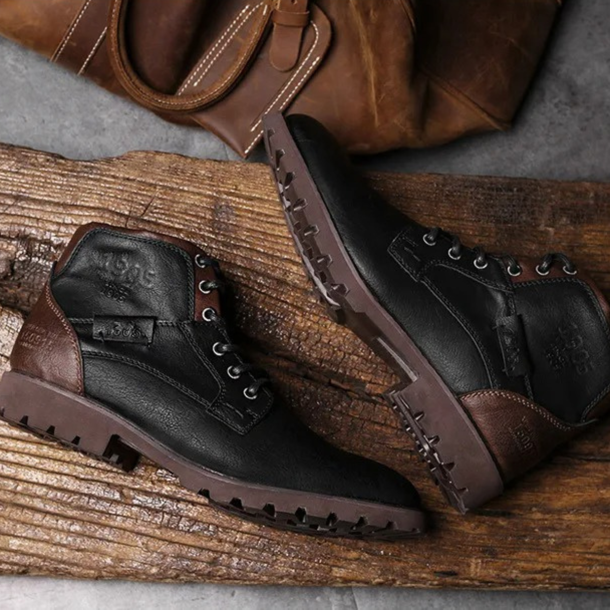 Black and brown lace-up leather combat boots with thick tread and side logo patch