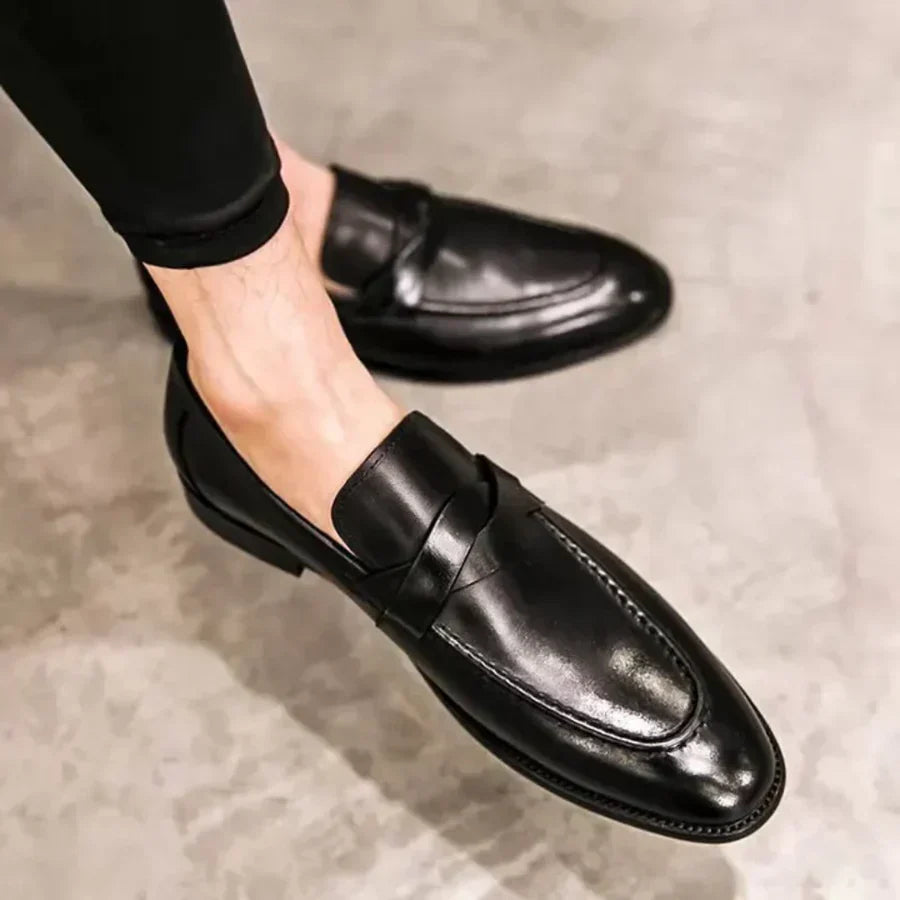 Black leather penny loafers, side view with penny strap and low block heel