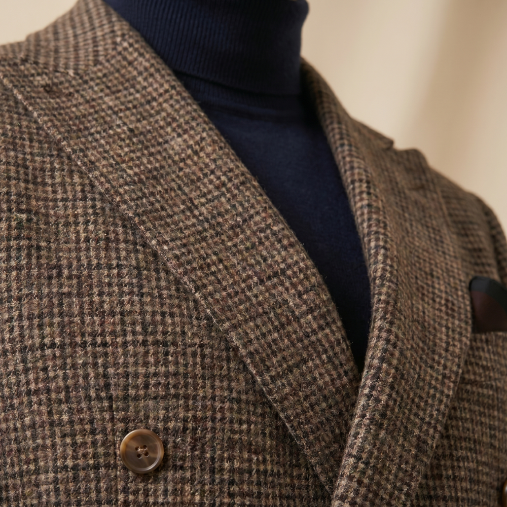 Brown herringbone tweed blazer lapel and button detail