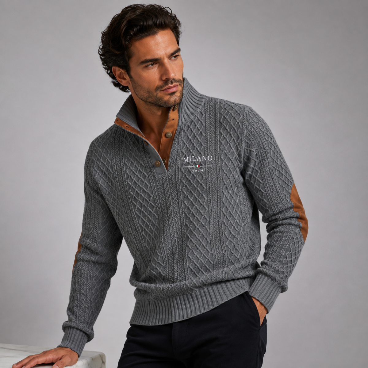 Men's quarter-zip knit sweater in gray with tan elbow patches, worn with dark pants