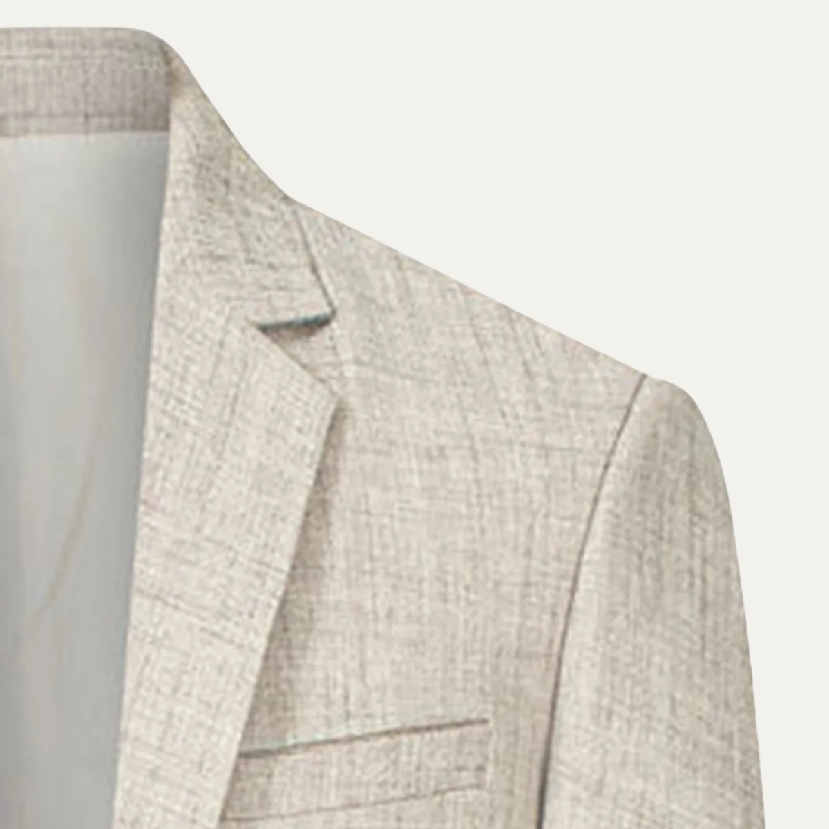 Men's beige blazer shoulder and lapel detail with front welt pocket