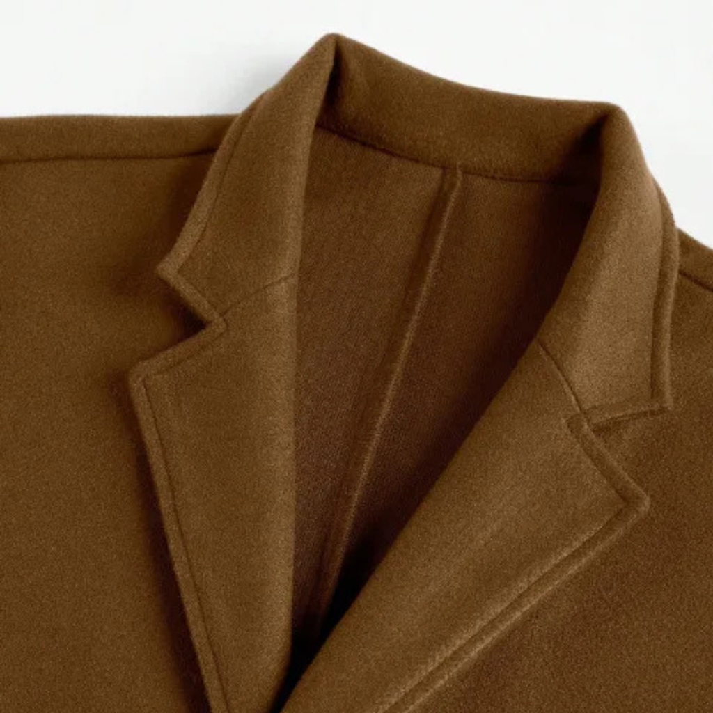 Men’s brown overcoat lapel detail with seam lines and inner facing at the collar