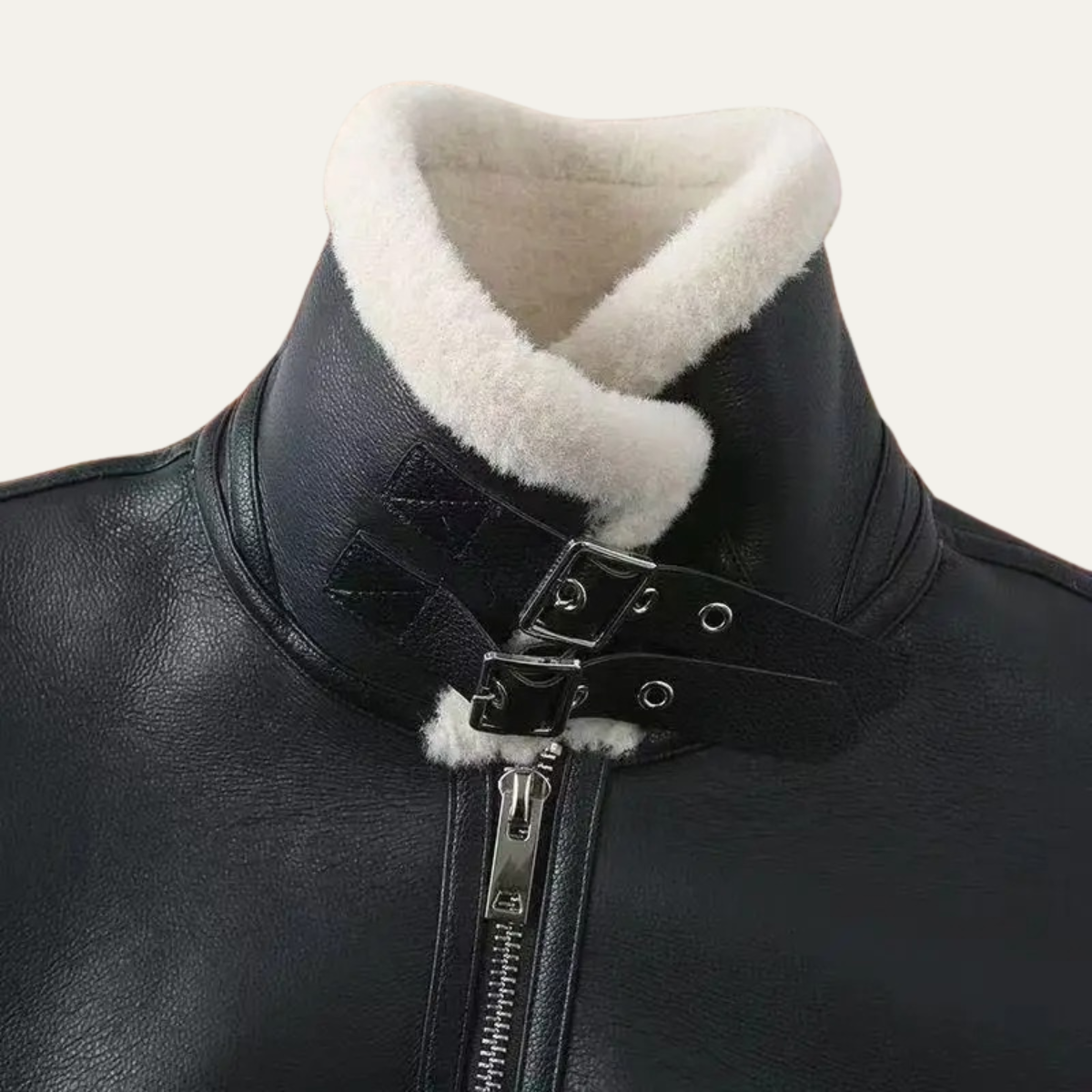 Black leather jacket close-up with cream sherpa collar and double buckle neck strap