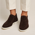 Men's dark-brown suede slip-on loafers with moc-style seam and white rubber sole.