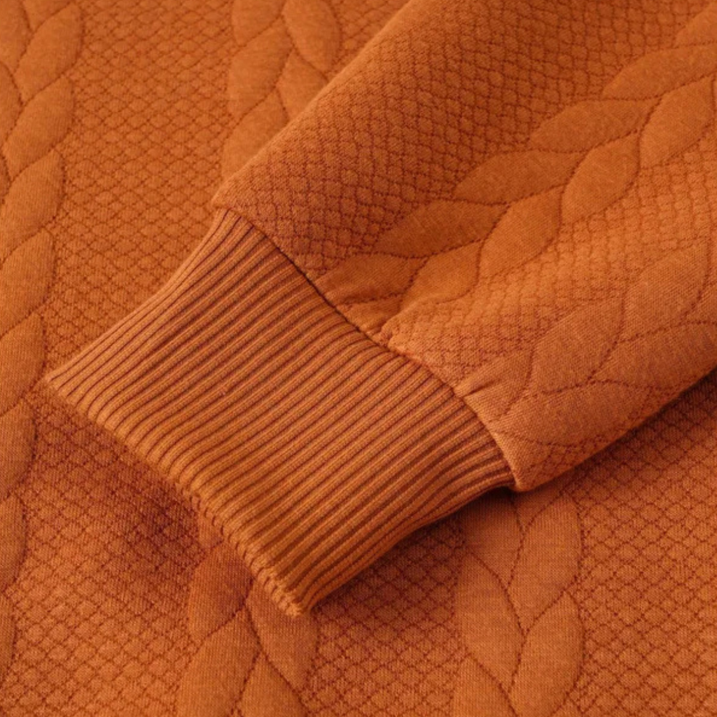 Men's cable knit turtleneck sleeve detail, rust orange ribbing
