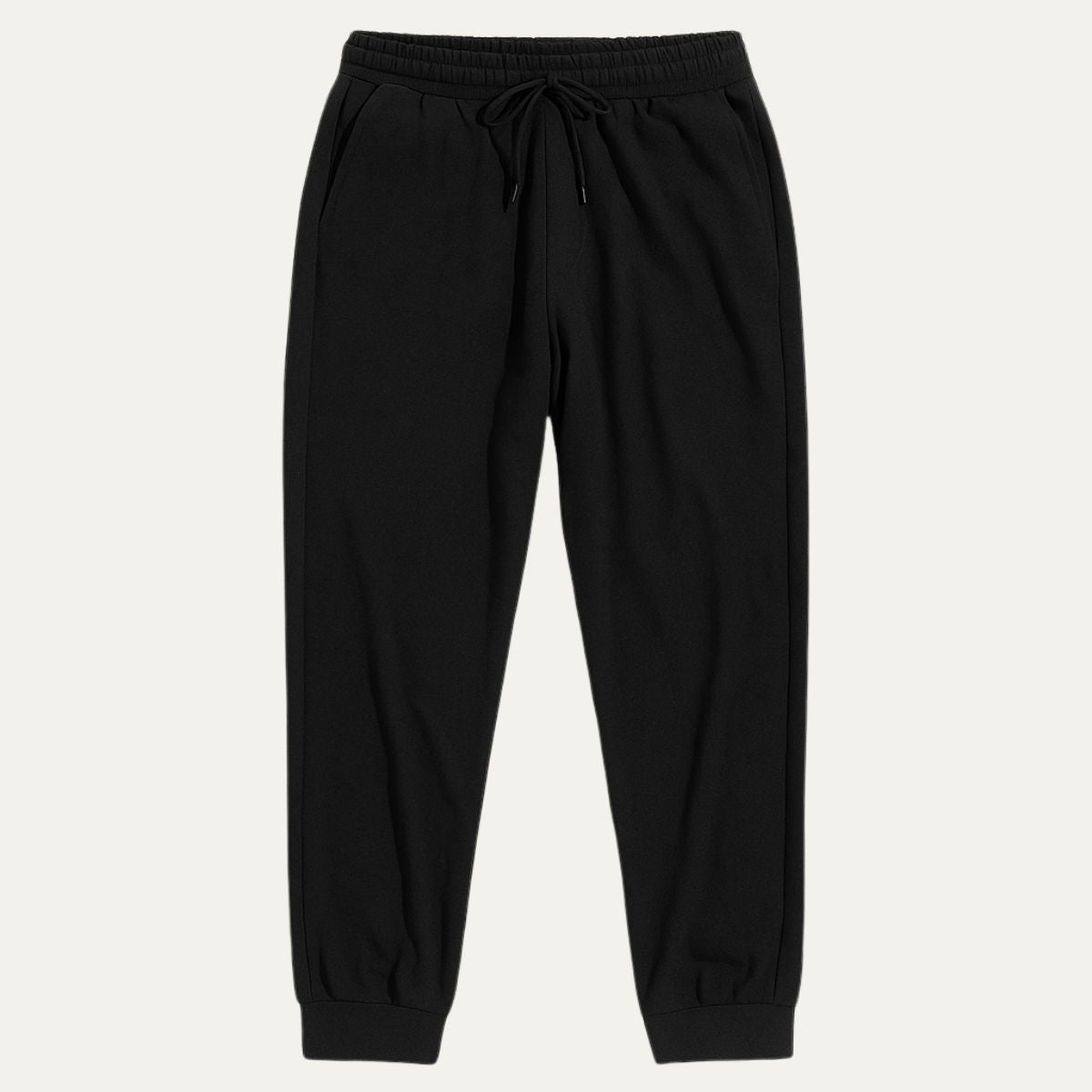 Black cotton jogger pants with elastic waistband, drawstring, and tapered ankle cuffs