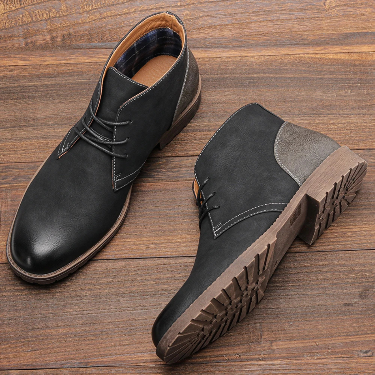 Black lace-up ankle boots with rugged tread sole and gray side accent panel