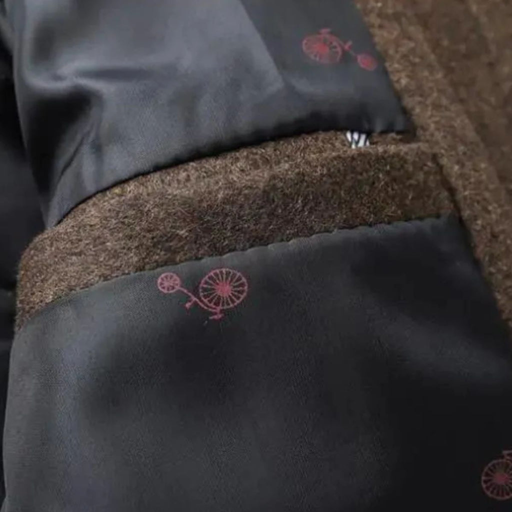 Brown coat interior lining with red pattern and seam stitching near hem.