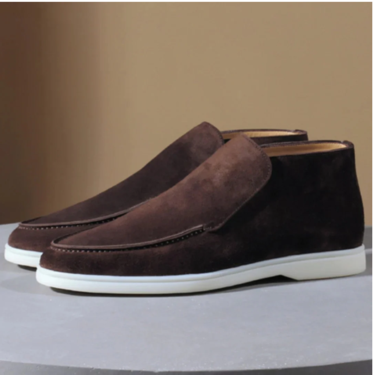 Men's dark-brown suede slip-on loafers with side gore and white rubber sole.