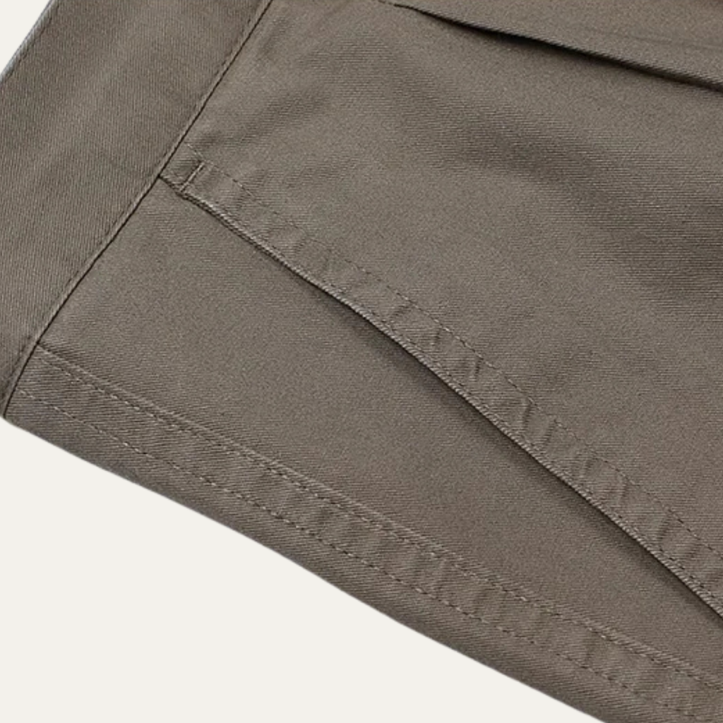 Men's double-pleated high-waist straight-leg pants in gray, stitched fabric seam close-up