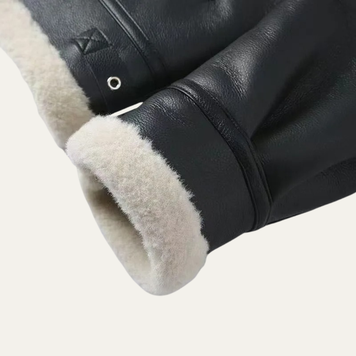 Black leather jacket sleeve close-up with cream sherpa cuff