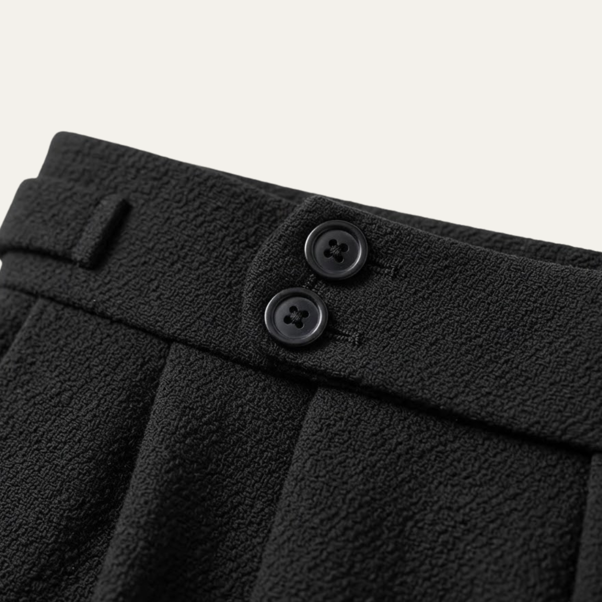 Black textured dress pants waistband with two button closures and belt loops