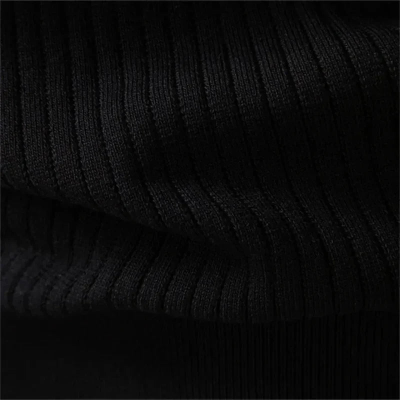 Black ribbed knit fabric detail on a men's henley sweater