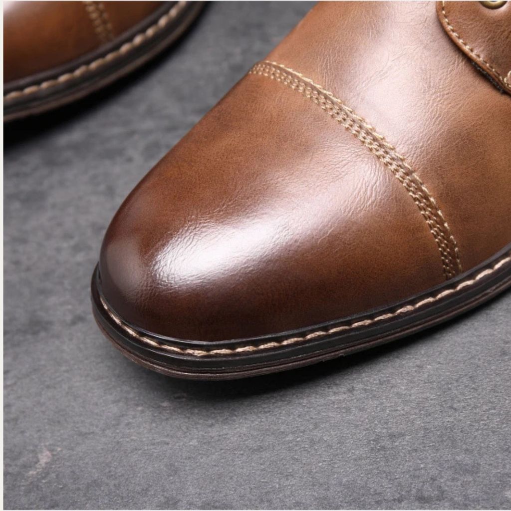 Brown boot toe with stitched upper and layered sole edge
