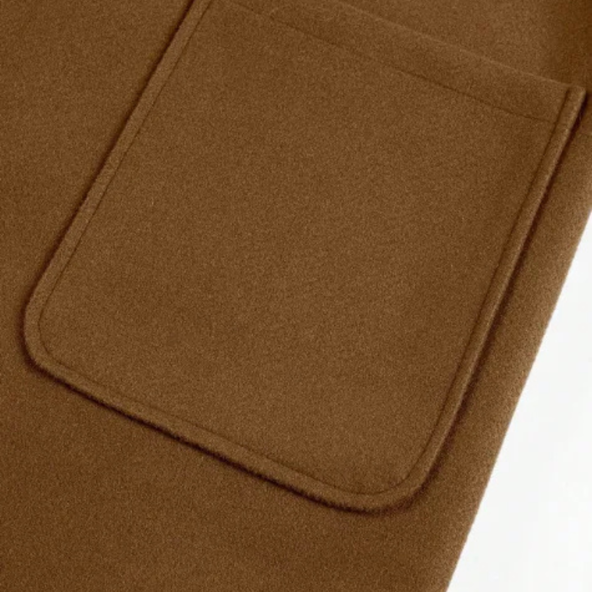 Men’s brown overcoat front flap pocket with curved pocket opening