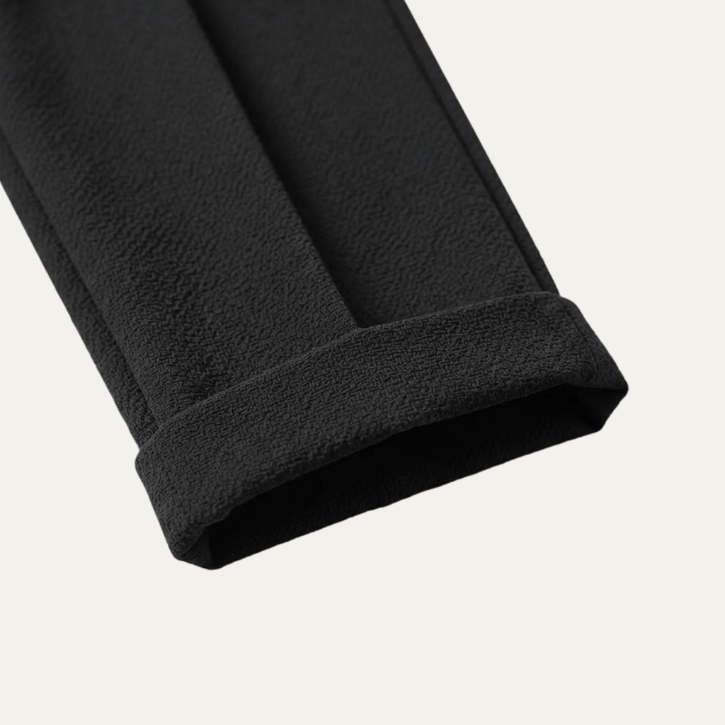 Black textured dress pants leg cuff and hem detail