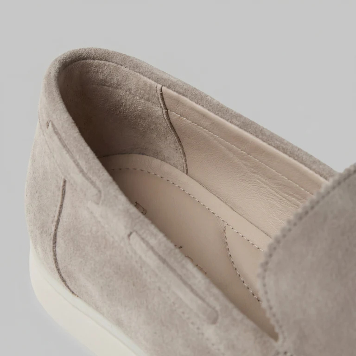 Beige suede slip-on loafer interior view with smooth lining and stitched opening