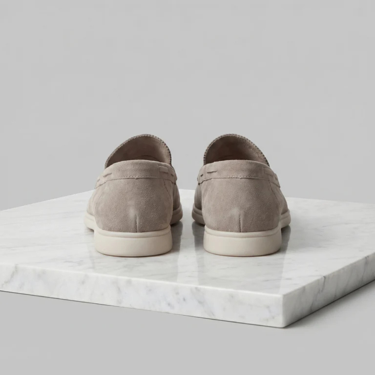 Men's beige suede slip-on loafers, rear view with heel seam and white sole