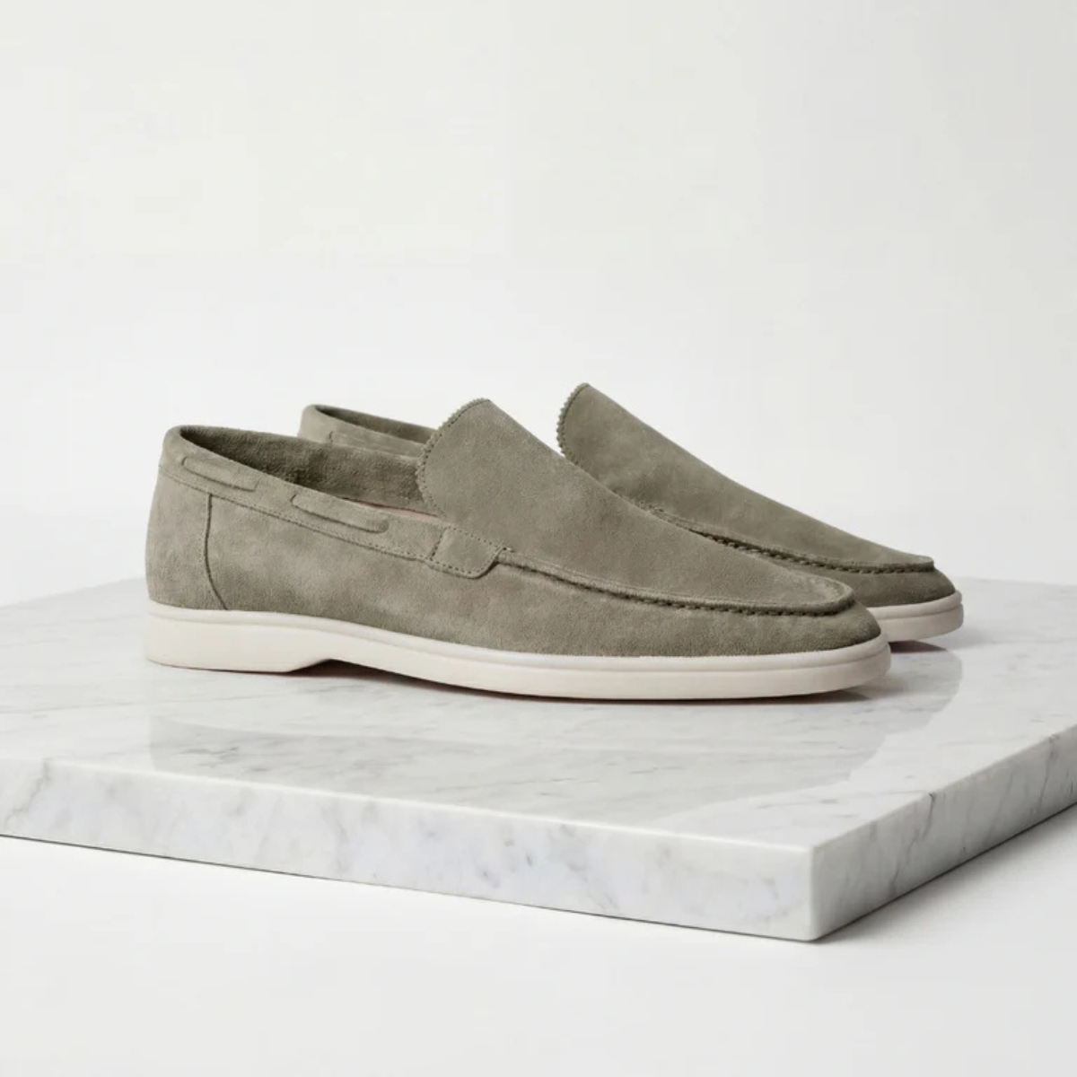Men's olive green suede slip-on loafer with moc-style stitching and white sole