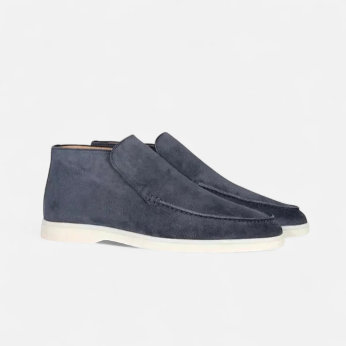 Navy blue suede slip-on loafers with moc-stitched detail and white rubber sole