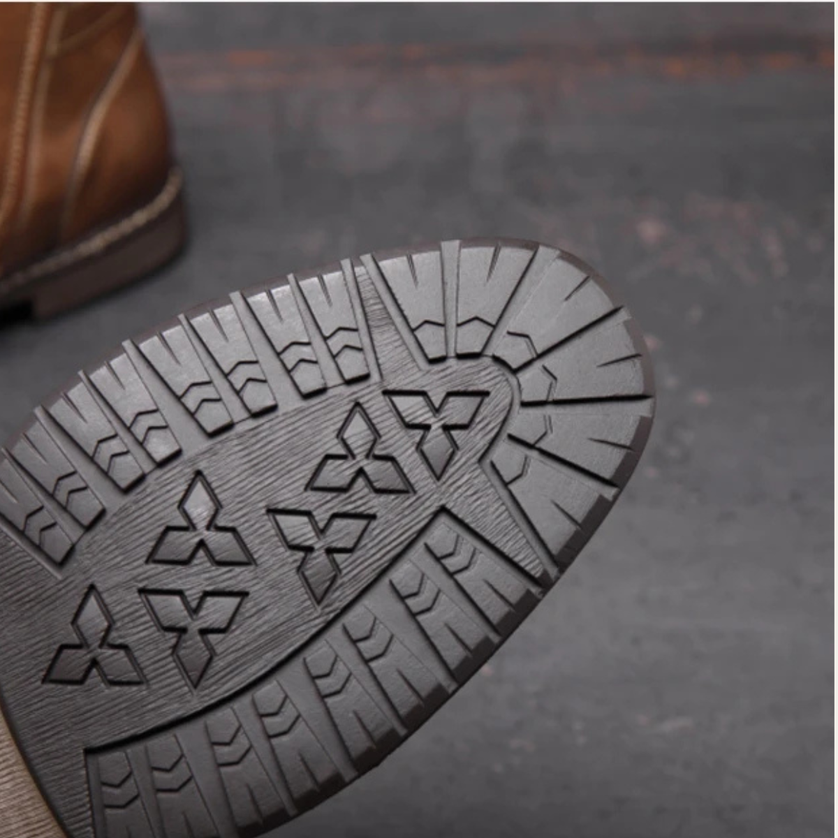 Boot outsole with patterned tread for rugged traction