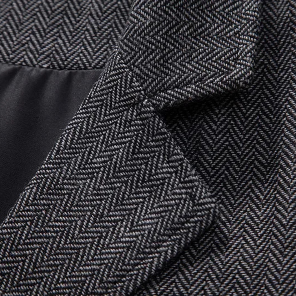 Dark gray tweed fabric close-up with herringbone texture detail