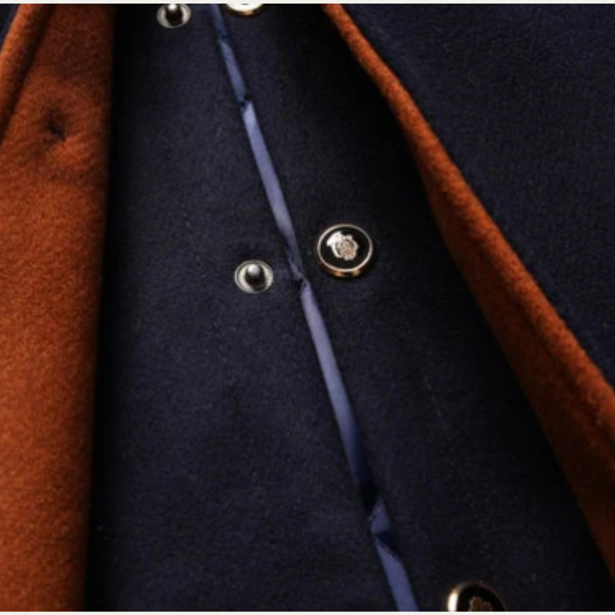 Men's wool coat front with navy lapels and metal button closure