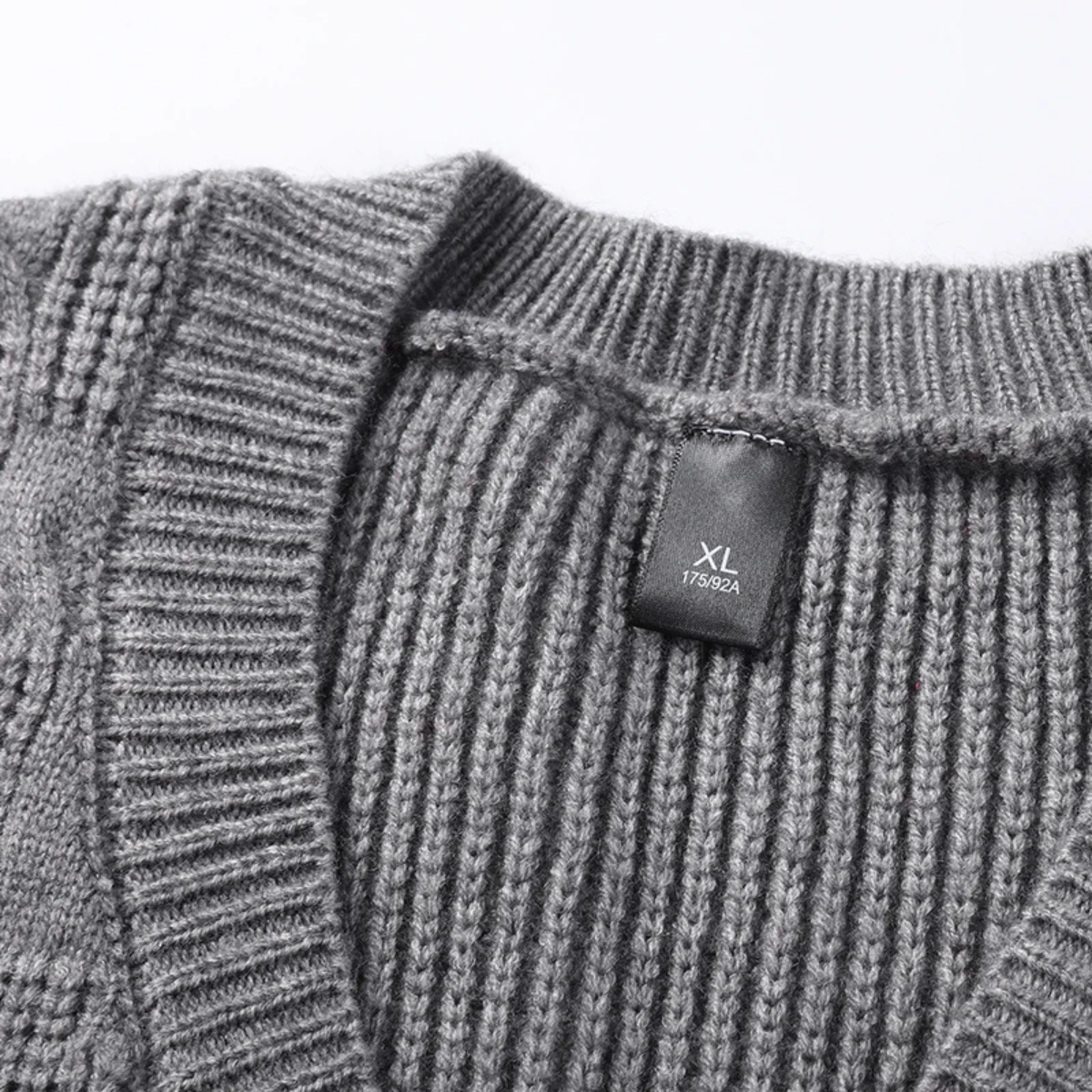 Men's gray textured knit V-neck sweater vest with ribbed trim and size XL label
