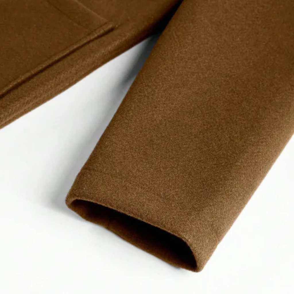 Men’s brown overcoat hem close-up with clean lining edge