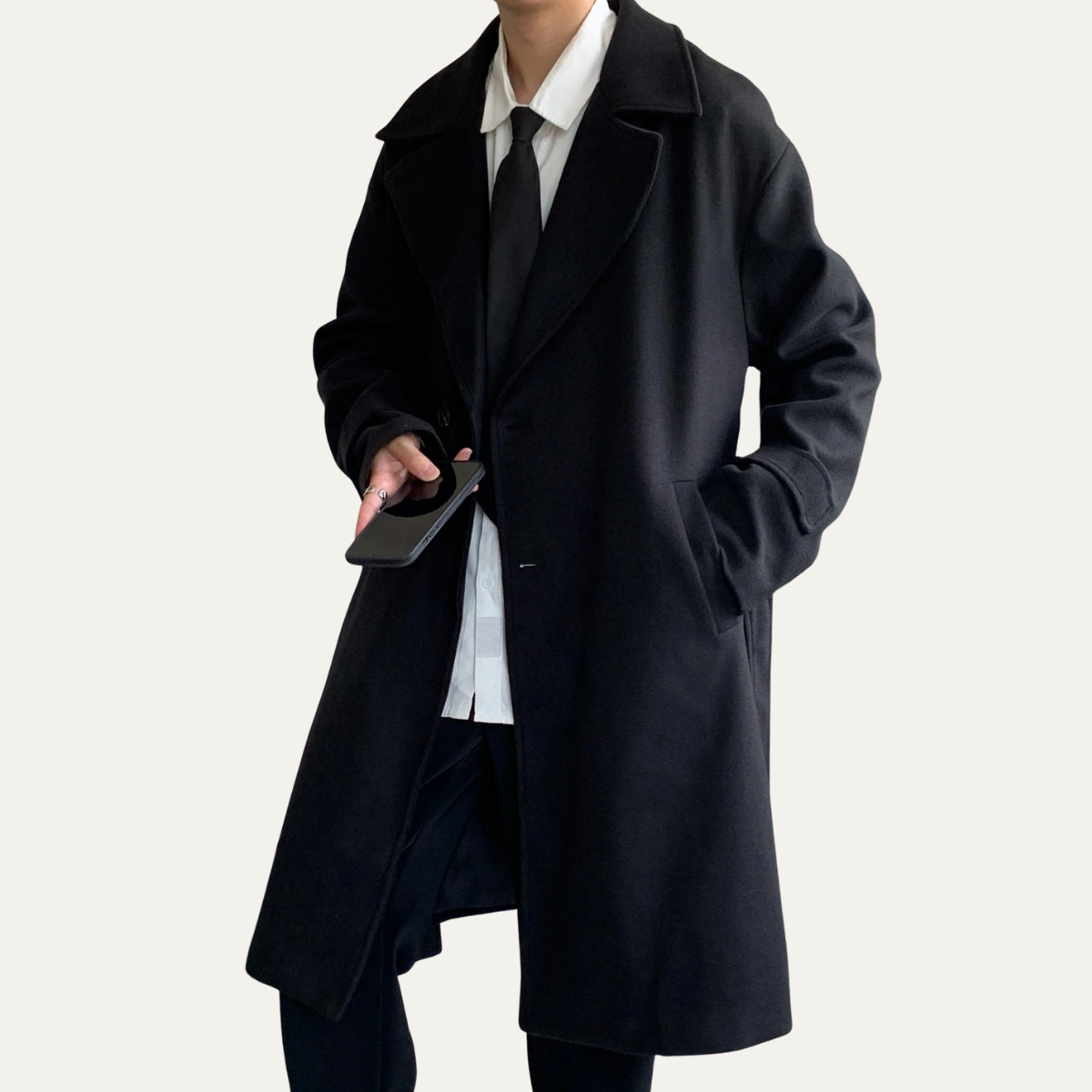 Black wool overcoat with notch lapels and long sleeves, button front