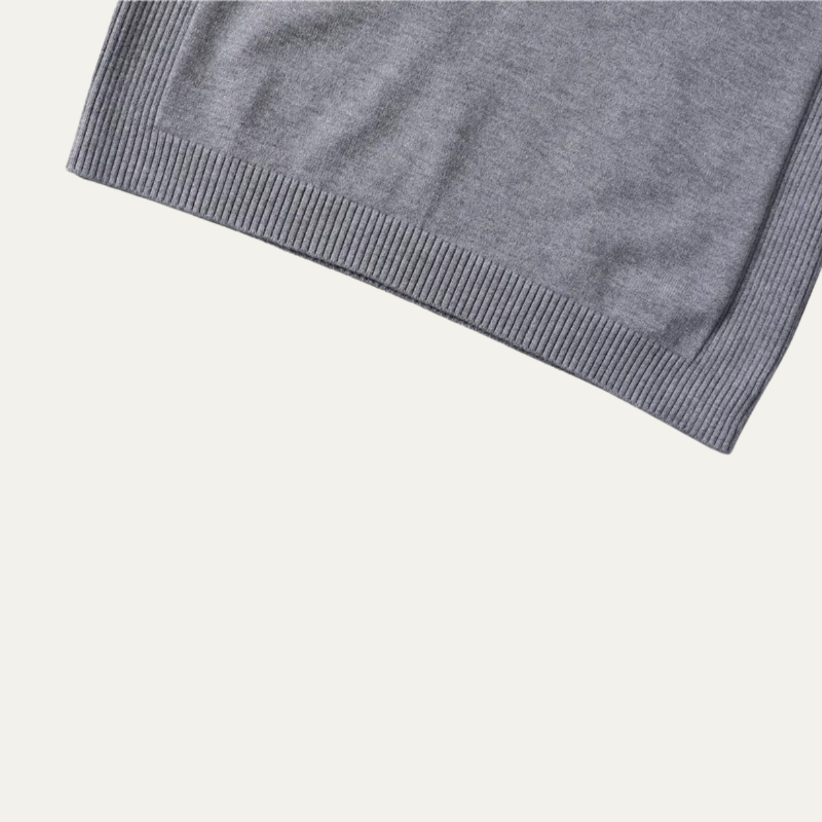 Gray turtleneck sweater cuff and ribbed waistband hem detail