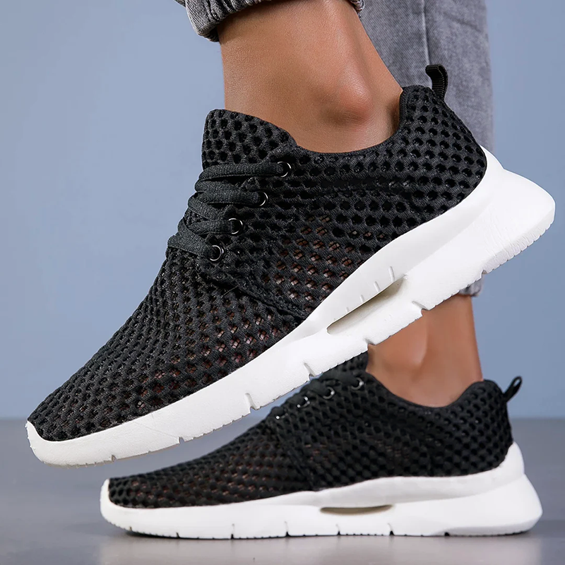 Black mesh sneakers with flexible sole, lace-up, breathable textured upper
