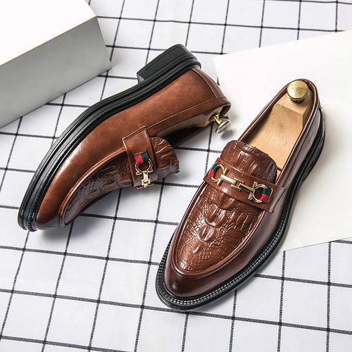 Brown embossed leather loafers with metal buckle strap and black rubber sole